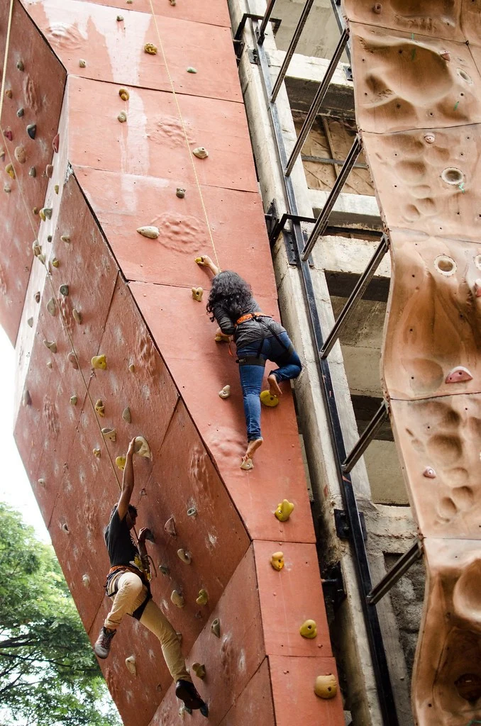 A participant ascending a climbing wall during the 2014 Adventure.