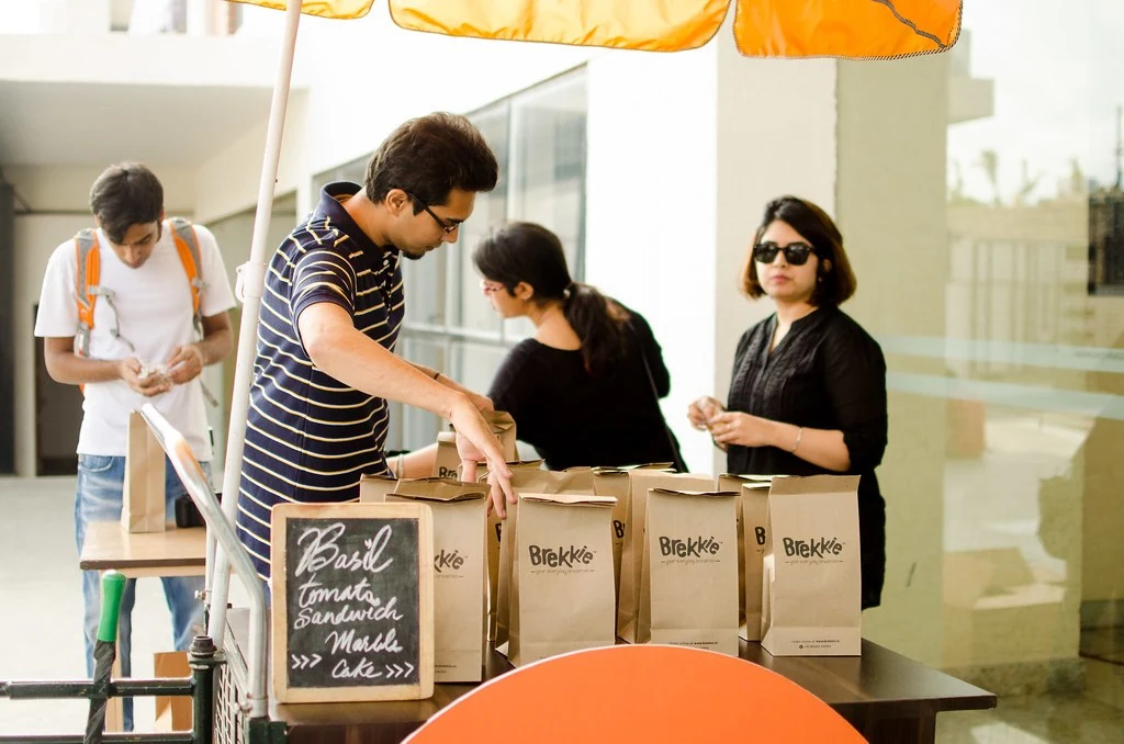 A participant writing at a registration table at All or Nothing.