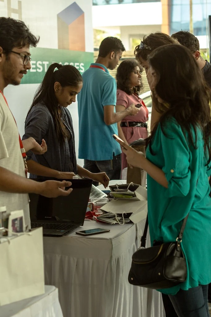 An attendee speaking with the registration team at All or Nothing.