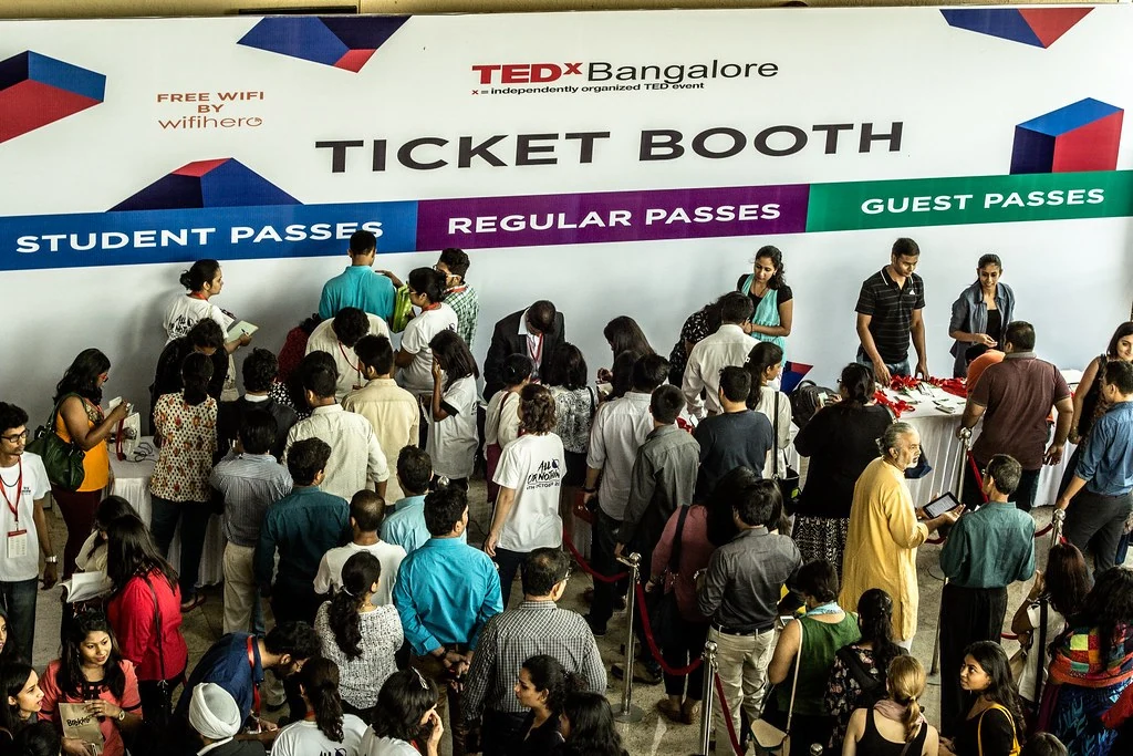 A busy ticket booth welcoming attendees at All or Nothing.
