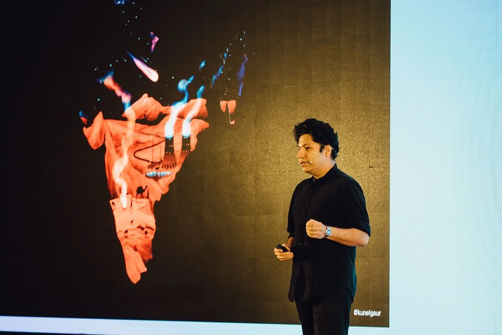 A speaker presenting with a performance image behind him at Beyond Resilience.