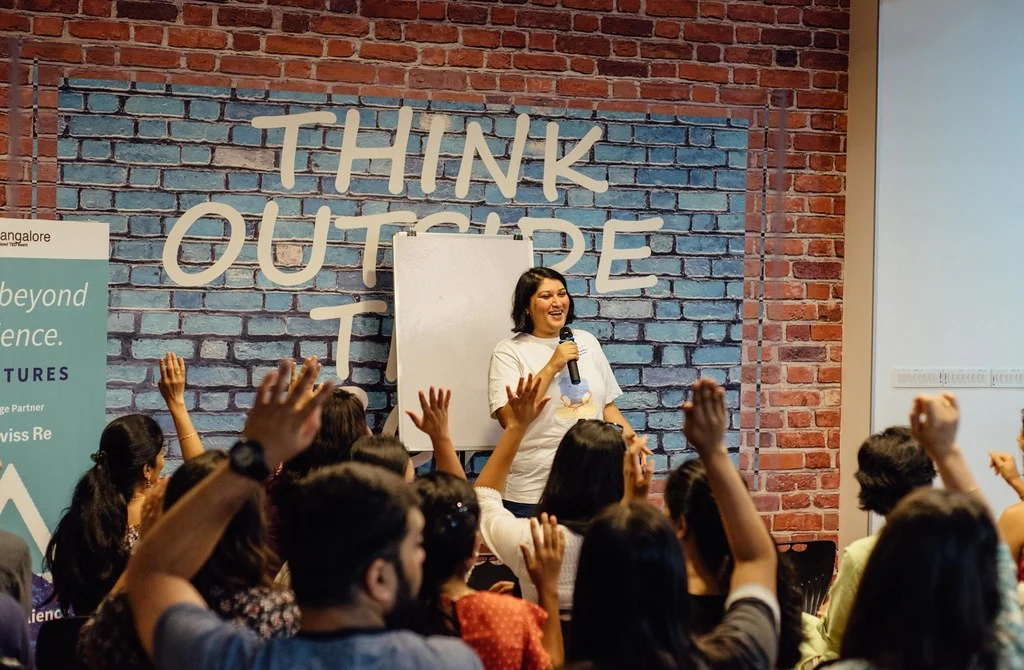 Participants raising their hands during the Mental Health 101 session.