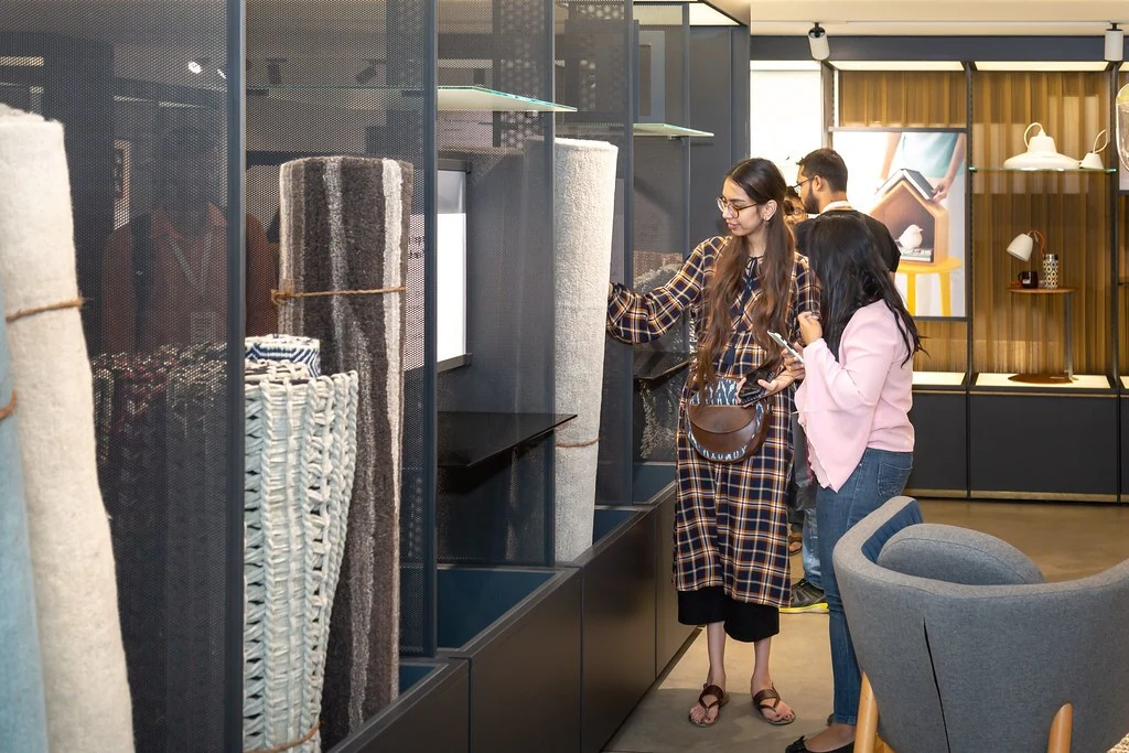 Two participants discussing among the displays at Nudge.