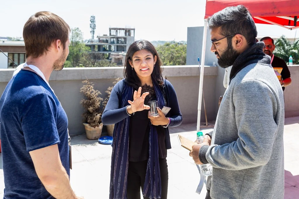 A small group exchanging ideas outdoors at Nudge.