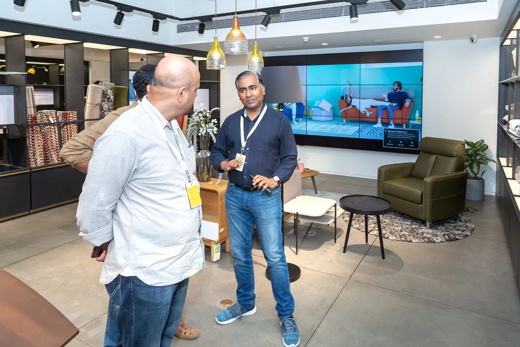 Two attendees exchanging ideas inside at Nudge.