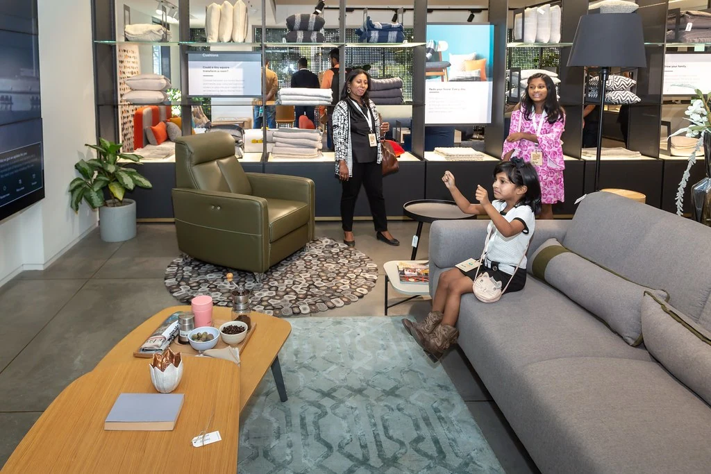 Participants talking among showroom furniture at Nudge.
