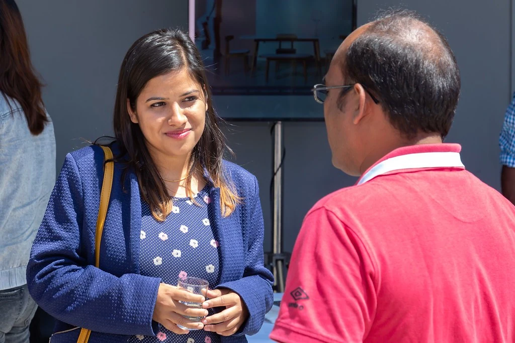 A participant in conversation near the terrace at Nudge.