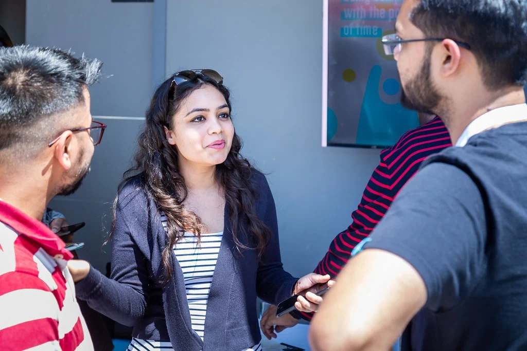 A participant speaking during an outdoor conversation at Nudge.