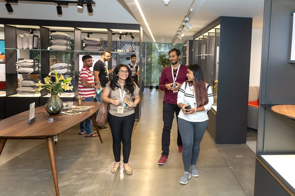 Attendees exploring the furnished event space at Nudge.