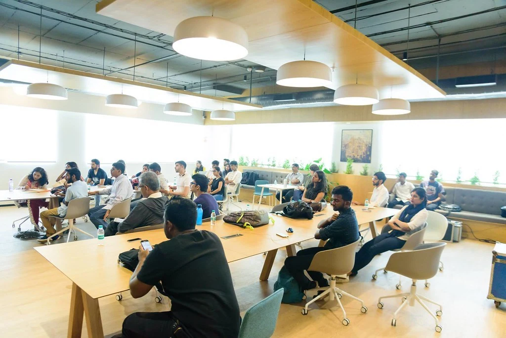 A wide view of participants seated at shared tables at Purpose & Progress.