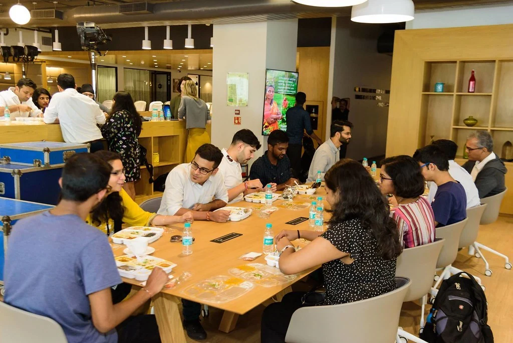 A group discussing ideas around a table at Purpose & Progress.