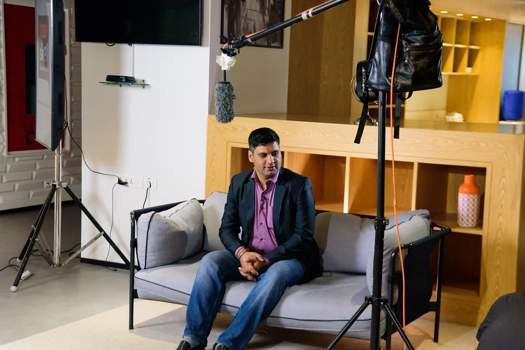 A participant being interviewed on camera at Purpose & Progress.