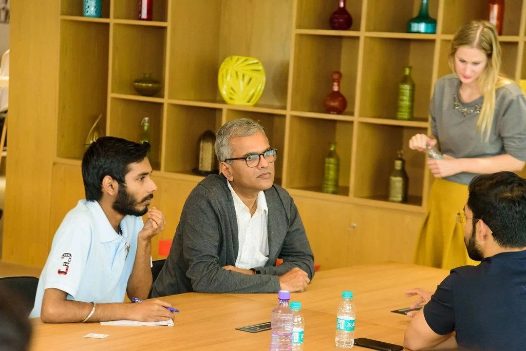 A facilitator listening to participants at Purpose & Progress.