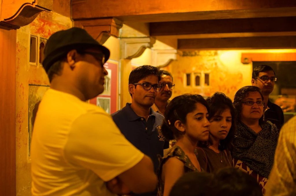 Participants listening together inside a historic building during the 2015 Unconference.