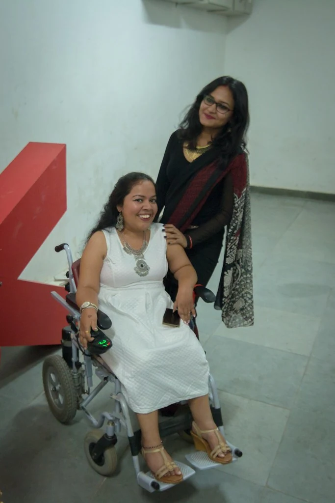 A participant speaking with seated attendees at TEDxBangaloreWomen.