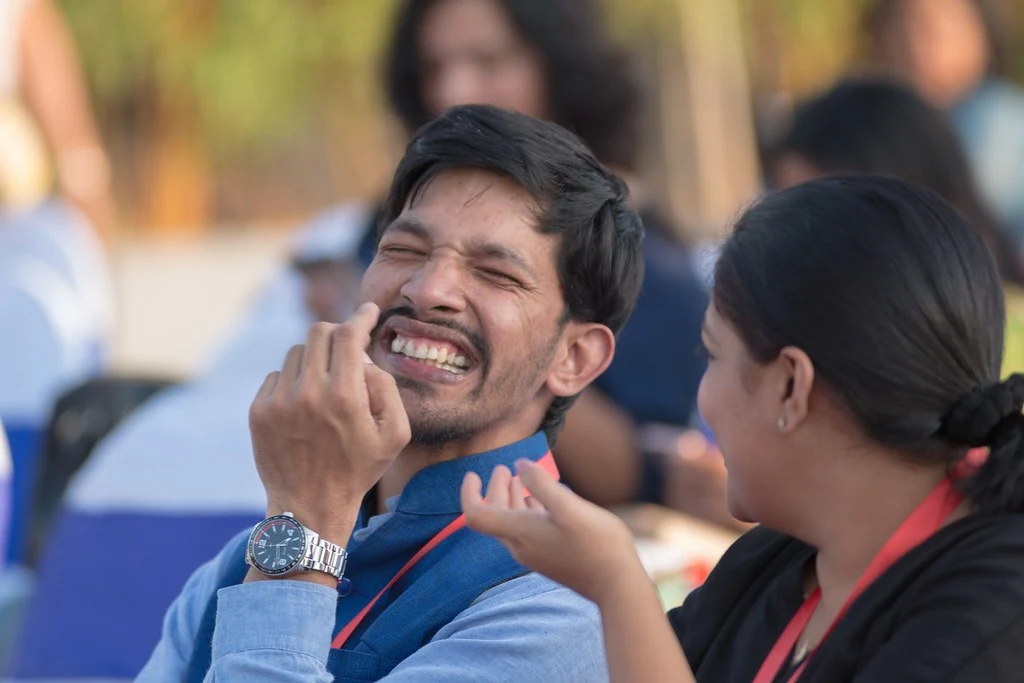 An attendee laughing during a conversation at TEDxBangaloreWomen.