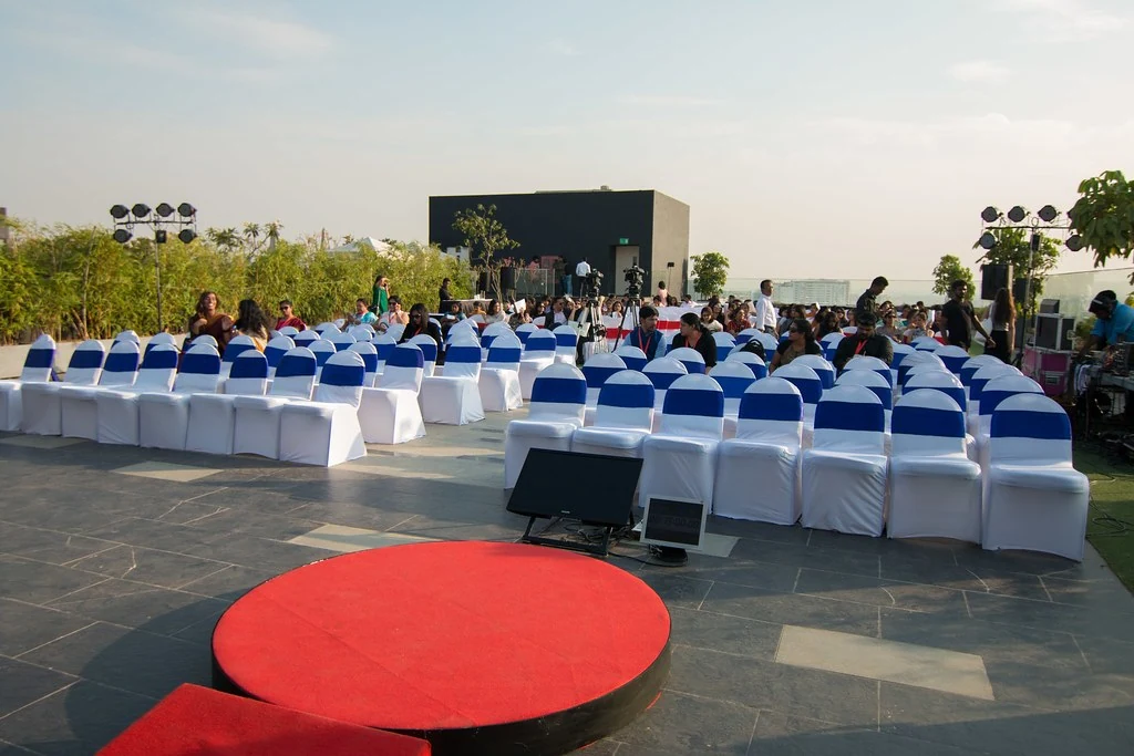 An outdoor stage and chairs prepared for the gathering at TEDxBangaloreWomen.